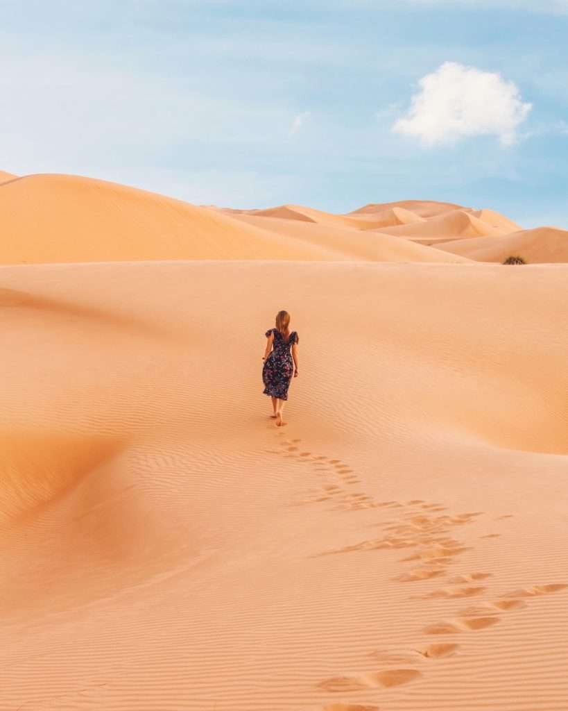 woman walking at desert